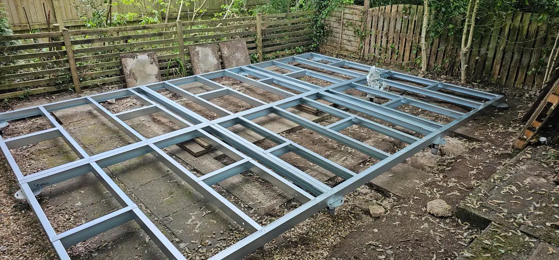 Light gauge steel base frame positioned on ground-screw heads