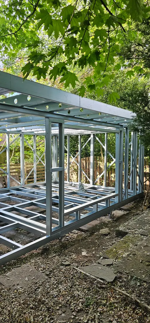 Erected light gauge steel garden-room structural shell on a residential site