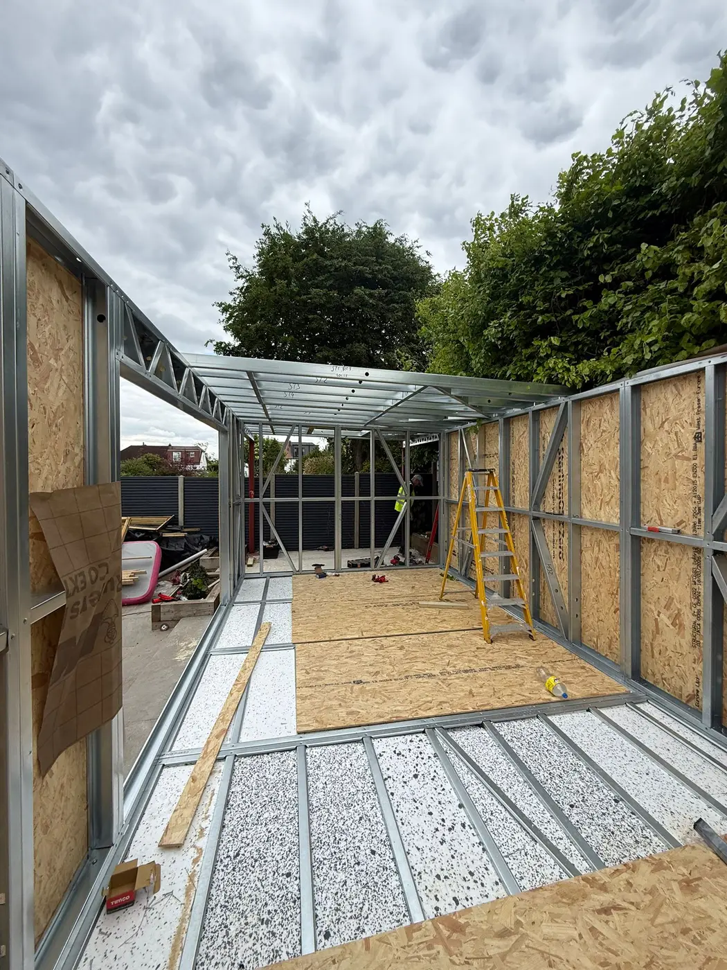 Interior erection view of a Forti Nova steel frame with sheathing and insulated floor cassettes
