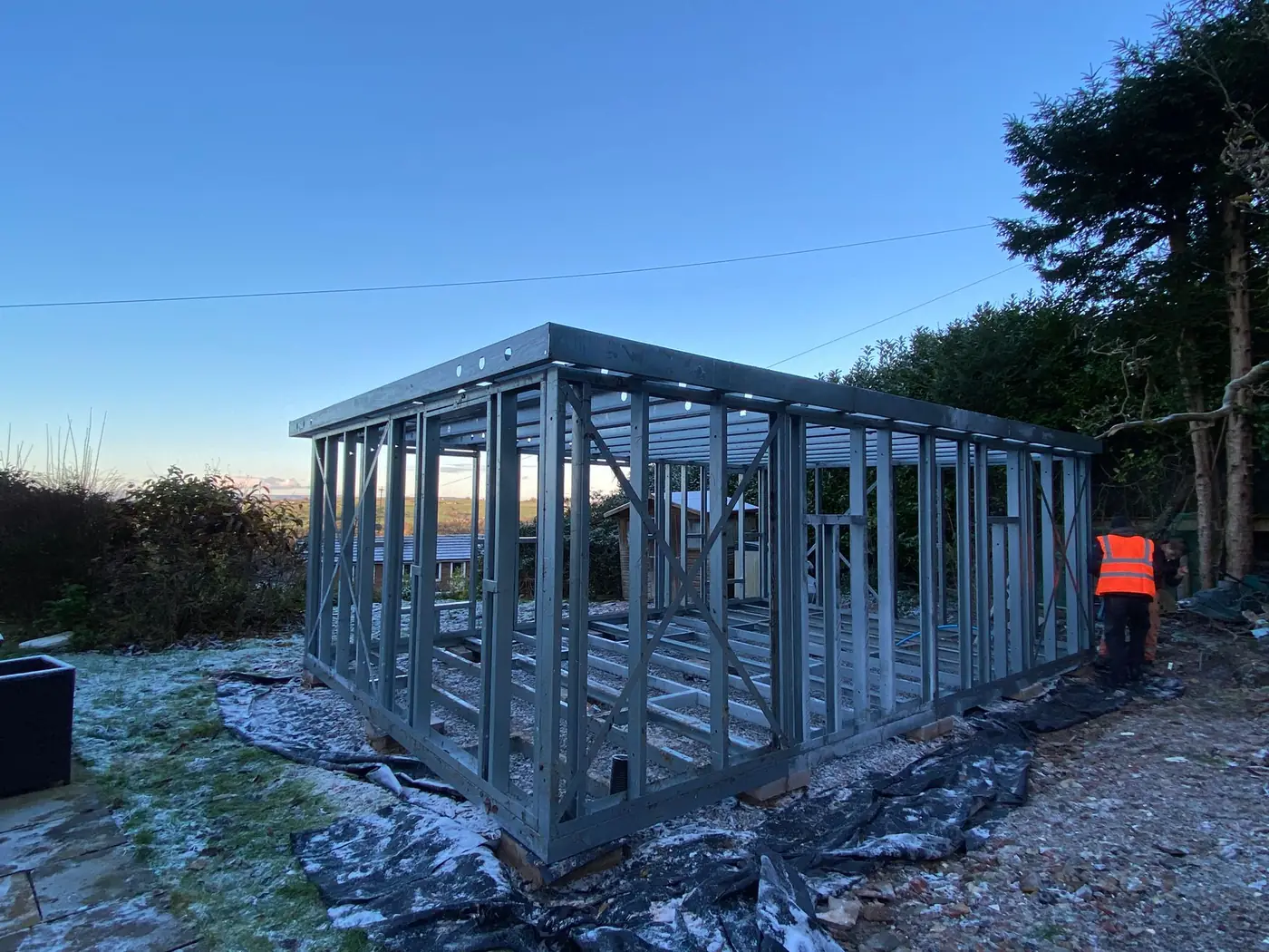 Forti Nova light gauge steel garden room frame during erection on a winter residential site